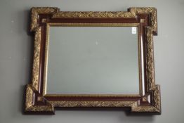 20th century wall mirror in simulated rosewood and gilt frame,