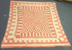 Two early 20th century Durham patchwork quilts, one having red geometric design on plain ground,