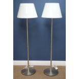 Pair burnished chrome standard lamps on circular bases with white tapered glass shades,