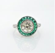 White gold emerald and diamond circular ring, hallmarked 14ct, central diamond 1.