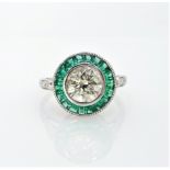 White gold emerald and diamond circular ring, hallmarked 14ct, central diamond 1.