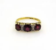 Three stone garnet and diamond gold ring stamped 18ct Condition Report Approx 3.