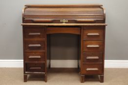 Early 20th century oak desk, tambour roll top enclosing fitted interior,