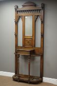 Early 20th century oak hall stand, central bevelled mirror above carved panel, hinged compartment,