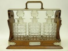 Oak and silver-plated mounted three bottle tantalus,