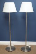 Pair burnished chrome standard lamps on circular bases with white tapered glass shades,
