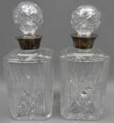 Pair of facet and fan cut square glass decanters with silver collars, hallmarked Birmingham 1957,