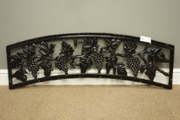 Arched cast iron bench back decorated with grapes and foliage, W116cm,