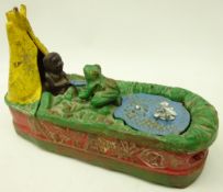 American cold painted cast iron money box modelled as a figure feeding a frog,