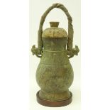 Chinese archaic style bronze ritual wine vessel and cover, cast in relief with bovine masks,