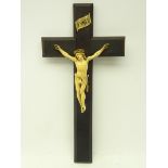 19th century continental carved ivory Corpus Christi, on later ebonised crucifix,
