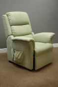 Electric reclining armchair upholstered in pale green fabric,