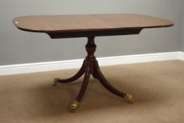 Regency style mahogany pedestal extending dining table with additional leaf,