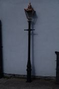 Victorian style cast iron street lamp post with copper and glass lantern top,