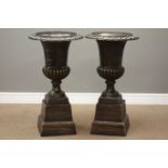 Pair Victorian style bronze finish cast iron urns on plinths D45cm,