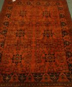 Afghan red ground rug decorated with Heretti and stylized motifs,