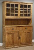 Early 20th century waxed pine dresser, raised cupboards enclosed by glazed doors,
