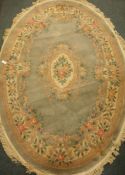 Oval jade ground Chinese washed woollen rug, with original receipt,