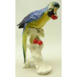 Karl Ens model of a parrot perched upon a branch eating cherries,