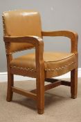 Mid 20th century oak armchair with sprung seat upholstered in tan leather with stud detailing,