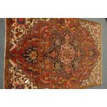 Persian Meshed carpet, large central stylised medallion on red field,