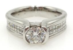 White gold diamond ring with diamond shoulders, tension set central diamond 0.