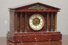 Late 19th century French rouge marble mantle clock, architectural cased with gilt metal columns,