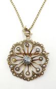 Early 20th century aquamarine and seed pearl rose gold flower pendant/brooch stamped 9ct with gold