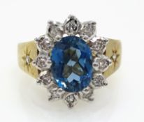 9ct gold oval blue topaz and diamond cluster ring hallmarked Condition Report