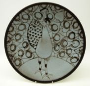 Poole pottery Aegean circular charger decorated with a peacock by Ros Sommerfelt,