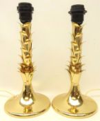 Pair gilt metal table lamps with applied leaf moulded stems on circular bases,