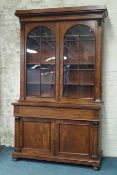 Large Victorian mahogany bookcase on cupboard, raised arched astragal glazed doors,