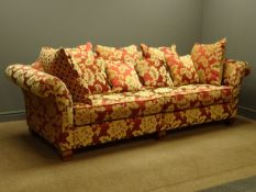 Grande four seat sofa upholstered in red and gold floral fabric, with scatter cushions, W255cm,