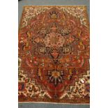 Persian Meshed carpet, large central stylised medallion on red field,
