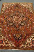 Persian Meshed carpet, large central stylised medallion on red field,