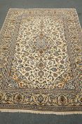 Persian Kashan ivory ground rug, blue floral design with repeating border,