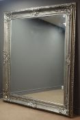 Large rectangular bevelled edge wall mirror in ornate swept silvered frame,