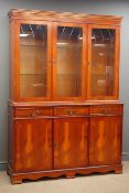 Reproduction yew wood display cabinet, three glazed doors above three drawers and three cupboards,