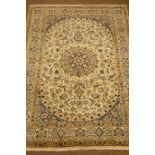 Fine Persian Nain ivory ground carpet, central medallion with scroll decorated field,