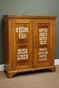 Edwardian oak side cabinet, rectangular top above two panelled doors with later 'O'Brians & Sons,