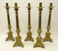 Set of five large brass candlesticks, corinthian column stem,