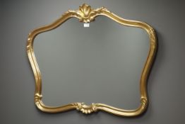 Gilt framed wall mirror with shell pediment,