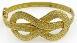 18ct gold hinged bangle, love knot design, stamped 750, approx 23.