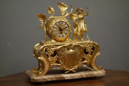 Late 20th century gilt metal figural mantel clock, decorated with scrolls and shell motifs,