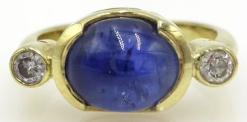 Gold ring set with cabochon sapphire and two diamonds,