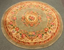 Chinese circular pale green gound washed woollen rug,