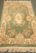 Chinese pale green ground washed wollen hearth rug,