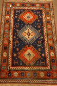 Turkish blue ground rug, geometric and stylised design,