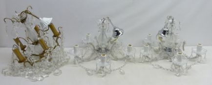 Pair of clear glass chandeliers with cut glass drops and scrolled arms and a similar chandelier (3)