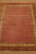 Persian pink ground rug, decorated with repeating Boteh motif,